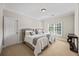 A neutral bedroom featuring carpeted floors, crown molding, and windows at 2517 Stone Manor Dr, Buford, GA 30519