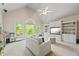 A bonus room with vaulted ceilings, carpeted floors, built-in cabinets, and natural light at 2517 Stone Manor Dr, Buford, GA 30519