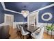 Dining room with chandelier, dark wood table, and modern decor at 2517 Stone Manor Dr, Buford, GA 30519