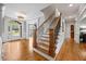 Elegant foyer with staircase, hardwood floors, decorative molding, and front door with sidelights at 2517 Stone Manor Dr, Buford, GA 30519