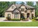Charming home with brick and stone facade, lush lawn and landscaping at 2517 Stone Manor Dr, Buford, GA 30519