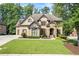 Beautiful brick home featuring manicured lawn and a stone-accented entrance at 2517 Stone Manor Dr, Buford, GA 30519