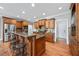 Gourmet kitchen with custom wood cabinets, granite countertops, stainless appliances, and center island at 2517 Stone Manor Dr, Buford, GA 30519