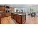 Kitchen features an island with granite countertop and seating area, open to the dining area at 2517 Stone Manor Dr, Buford, GA 30519