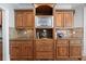 Kitchen with custom wood cabinetry, granite countertops, and stainless steel appliances at 2517 Stone Manor Dr, Buford, GA 30519