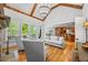 Bright living room with vaulted ceiling, stone fireplace, hardwood floors and view into kitchen at 2517 Stone Manor Dr, Buford, GA 30519