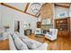 Living room featuring exposed beams, stone fireplace, hardwood floors and comfortable seating at 2517 Stone Manor Dr, Buford, GA 30519