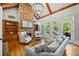 Comfortable living room with stone fireplace, built-in shelves, hardwood floors, and large windows at 2517 Stone Manor Dr, Buford, GA 30519