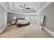 Spacious main bedroom with tray ceiling, sitting area, carpet flooring, and natural light at 2517 Stone Manor Dr, Buford, GA 30519