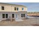 A rear exterior of a brick townhouse with a small patio and a grassy yard at 329 Heavenly Hollow Pl, Mcdonough, GA 30253
