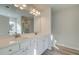 Bright bathroom featuring a double sink vanity with white cabinets, a large mirror, and modern lighting fixture at 329 Heavenly Hollow Pl, Mcdonough, GA 30253