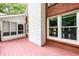 Back deck and screened porch with brick wall and white siding at 3648 Clark Hill Way, Buford, GA 30519