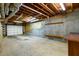 Unfinished basement with concrete floor and an open garage door at 3648 Clark Hill Way, Buford, GA 30519