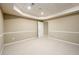 Spacious finished basement with neutral carpet and paint, and access to other rooms at 3648 Clark Hill Way, Buford, GA 30519