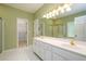 Bathroom featuring double vanity, white tile floor and access to a walk-in closet at 3648 Clark Hill Way, Buford, GA 30519