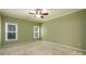 Cozy bedroom with neutral carpet, crown molding, and bright windows at 3648 Clark Hill Way, Buford, GA 30519