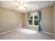 Cozy bedroom with a ceiling fan, soft carpet, and large window with curtains at 3648 Clark Hill Way, Buford, GA 30519