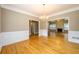 Open-concept dining room featuring hardwood floors and a chandelier, perfect for entertaining guests at 3648 Clark Hill Way, Buford, GA 30519