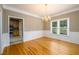 Elegant dining room with hardwood floors and adjacent kitchen view, creating a seamless flow at 3648 Clark Hill Way, Buford, GA 30519