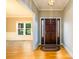 Inviting foyer with hardwood floors, a wooden front door, and views into the adjacent living spaces at 3648 Clark Hill Way, Buford, GA 30519