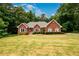 Beautiful brick home with landscaped front yard, featuring a walkway to the entrance and neat shrubbery at 3648 Clark Hill Way, Buford, GA 30519