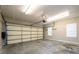 An empty two car garage with a standard garage door and two windows at 3648 Clark Hill Way, Buford, GA 30519
