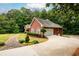 Side view of a brick home, revealing a two-car garage and a well-maintained lawn at 3648 Clark Hill Way, Buford, GA 30519