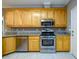 Bright kitchen features stainless steel appliances, granite countertops, and wooden cabinetry at 3648 Clark Hill Way, Buford, GA 30519