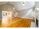 Bright living room with hardwood floors, vaulted ceilings, fireplace, and open layout at 3648 Clark Hill Way, Buford, GA 30519