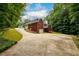 A brick home with a rear deck, screened-in porch, and lush landscaping at 3648 Clark Hill Way, Buford, GA 30519