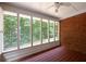 Screened porch with brick accent wall and view of backyard at 3648 Clark Hill Way, Buford, GA 30519