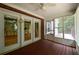 Covered porch with glass doors, ceiling fan, and view of backyard at 3648 Clark Hill Way, Buford, GA 30519