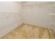 Functional walk-in closet with built-in shelving and neutral carpet at 3648 Clark Hill Way, Buford, GA 30519