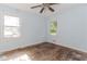 The bedroom features wood floors, two windows, and light blue walls at 1167 Sanders Dr, Morrow, GA 30260