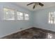 The bedroom features wood floors, three windows, and light blue walls at 1167 Sanders Dr, Morrow, GA 30260