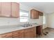 An outdated kitchen features damaged cabinets, a sink, and countertops at 1167 Sanders Dr, Morrow, GA 30260