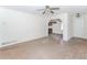 Bright living room with hardwood floors, white walls, and an open layout flowing into the kitchen at 1167 Sanders Dr, Morrow, GA 30260