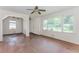 Open living space with hardwood floors, white walls, and large windows offering ample natural light at 1167 Sanders Dr, Morrow, GA 30260