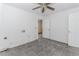 A room shows damaged tile flooring with two windows and a ceiling fan at 1167 Sanders Dr, Morrow, GA 30260
