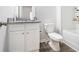 Bathroom features granite counters, white cabinetry, a soaking tub, and wood-look vinyl flooring at 11689 Mendenhall Ct, Hampton, GA 30228
