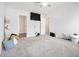 A mostly-empty bedroom offers neutral carpeting, a ceiling fan, and two windows allowing for plenty of natural light at 11689 Mendenhall Ct, Hampton, GA 30228
