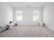 An empty bedroom offers neutral carpeting and two windows allowing for plenty of natural light at 11689 Mendenhall Ct, Hampton, GA 30228