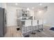 Modern kitchen featuring an island with bar stools, stainless steel appliances and stylish cabinets at 11689 Mendenhall Ct, Hampton, GA 30228