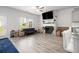 A cozy living area with fireplace, hardwood floors and great natural light at 11689 Mendenhall Ct, Hampton, GA 30228