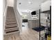 Bright open-concept living area featuring hardwood floors and a staircase at 11689 Mendenhall Ct, Hampton, GA 30228