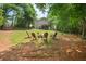 Large backyard featuring a fire pit with Adirondack chairs and a view of the home's deck at 124 Hunters Mill Rd, Woodstock, GA 30188