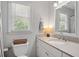 Bathroom featuring framed mirror, vanity, and window view at 124 Hunters Mill Rd, Woodstock, GA 30188