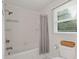 All white tiled tub and shower combination with window view at 124 Hunters Mill Rd, Woodstock, GA 30188