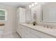 Bright bathroom featuring double vanity with white cabinets and framed mirrors at 124 Hunters Mill Rd, Woodstock, GA 30188