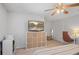 Bedroom featuring ceiling fan, shelving, and a cozy desk area at 124 Hunters Mill Rd, Woodstock, GA 30188